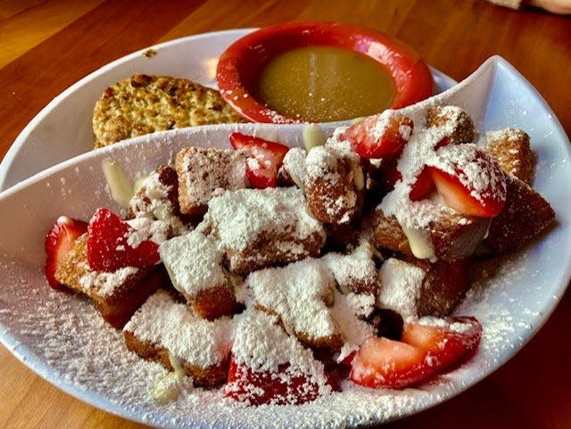 French Toast Bites from Ruby Sunshine, covered in powdered sugar and served with strawberries.