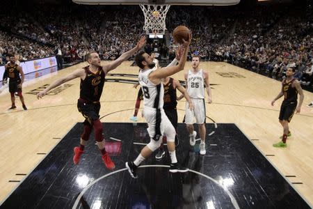 Mar 28, 2019; San Antonio, TX, USA; San Antonio Spurs shooting guard Marco Belinelli (18) shoots the ball against Cleveland Cavaliers shooting guard Nik Stauskas (1) during the second half at AT&T Center. Mandatory Credit: Soobum Im-USA TODAY Sports