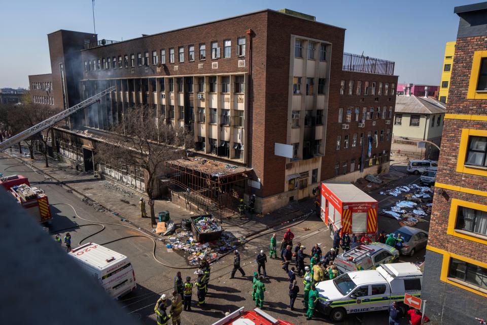 Medics and emergency works at the scene of a deadly blaze in downtown Johannesburg Thursday, Aug. 31, 2023.