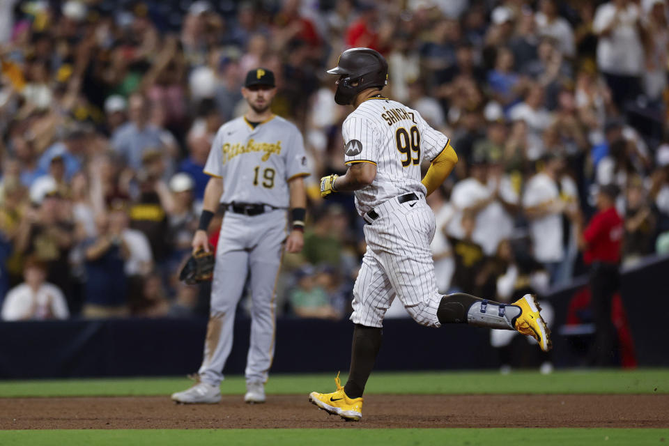 San Diego Padres' Gary Sanchez, right, runs the bases in front of Pittsburgh Pirates' Jared Triolo after hitting a two-run home run during the eighth inning of a baseball game Tuesday, July 25, 2023, in San Diego. (AP Photo/Derrick Tuskan)