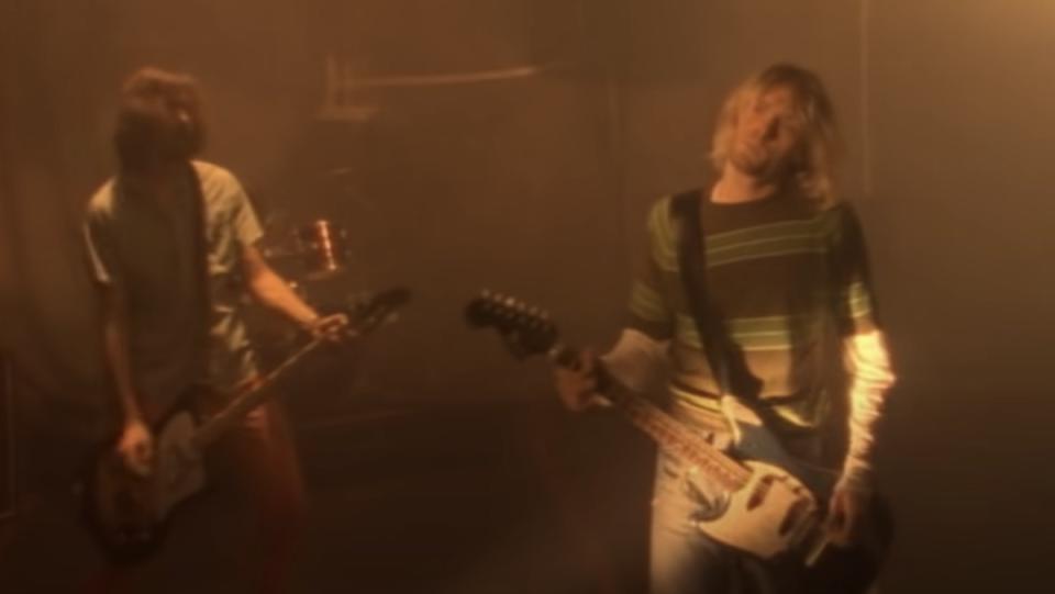 Kurt Cobain and Krist Novoselic in front of a basketball net Nirvana's "Smells Like Teen Spirit" video