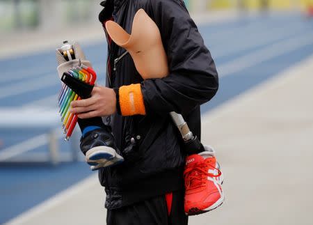 A staff holds prosthetics at an opening ceremony of a special "library" that lets people borrow and try out prosthetic "blades" for runners, in Tokyo, Japan, October 15, 2017. Picture taken October 15, 2017. REUTERS/Kim Kyung-Hoon