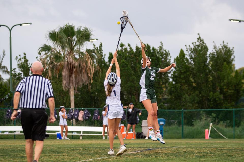 St. Edward's Carrington Brown (1) and Melbourne’s Mia Rozengota(2) go for the ball during the draw in a high school girls lacrosse game Wednesday, April 3, 2024, in Indian River County.