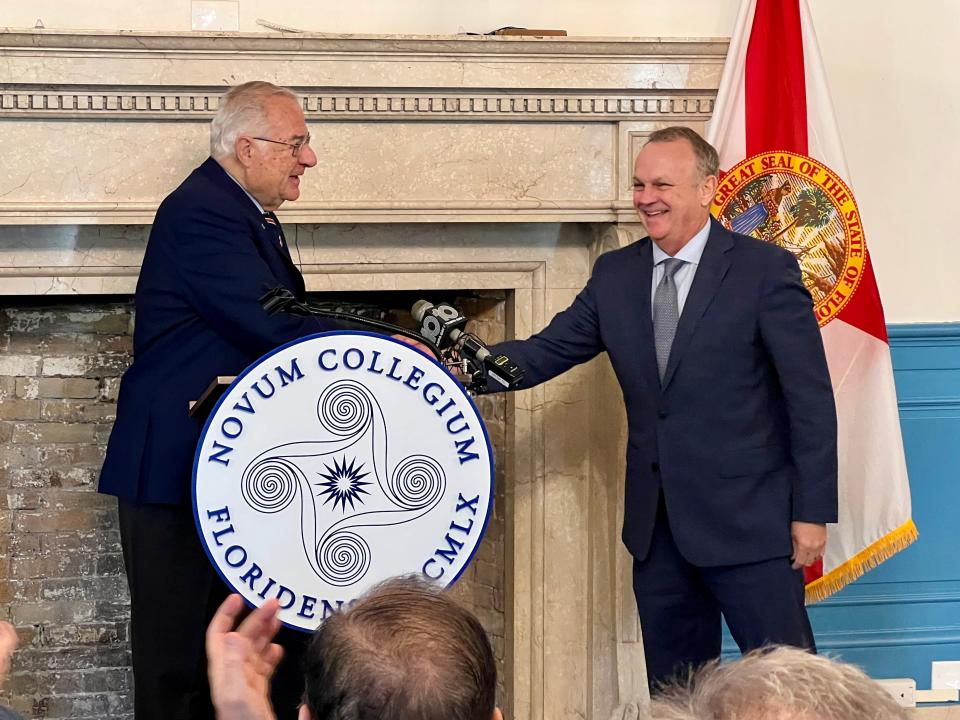 Joe Ricketts, founder of Ricketts Great Books College and owner of the Chicago Cubs, shakes hands with New College of Florida President Richard Corcoran at a press conference Thursday. The two unveiled a collaboration between Ricketts Great Books College and New College of Florida to provide an online classical liberal arts program.