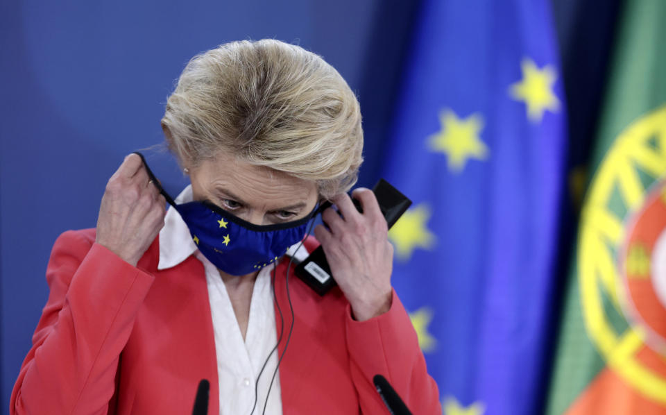 European Commission President Ursula von der Leyen takes off her protective face mask prior to addressing a media conference at an EU summit in Porto, Portugal, Saturday, May 8, 2021. On Saturday, EU leaders held an online summit with India's Prime Minister Narendra Modi, covering trade, climate change and help with India's COVID-19 surge. (AP Photo/Luis Vieira, Pool)