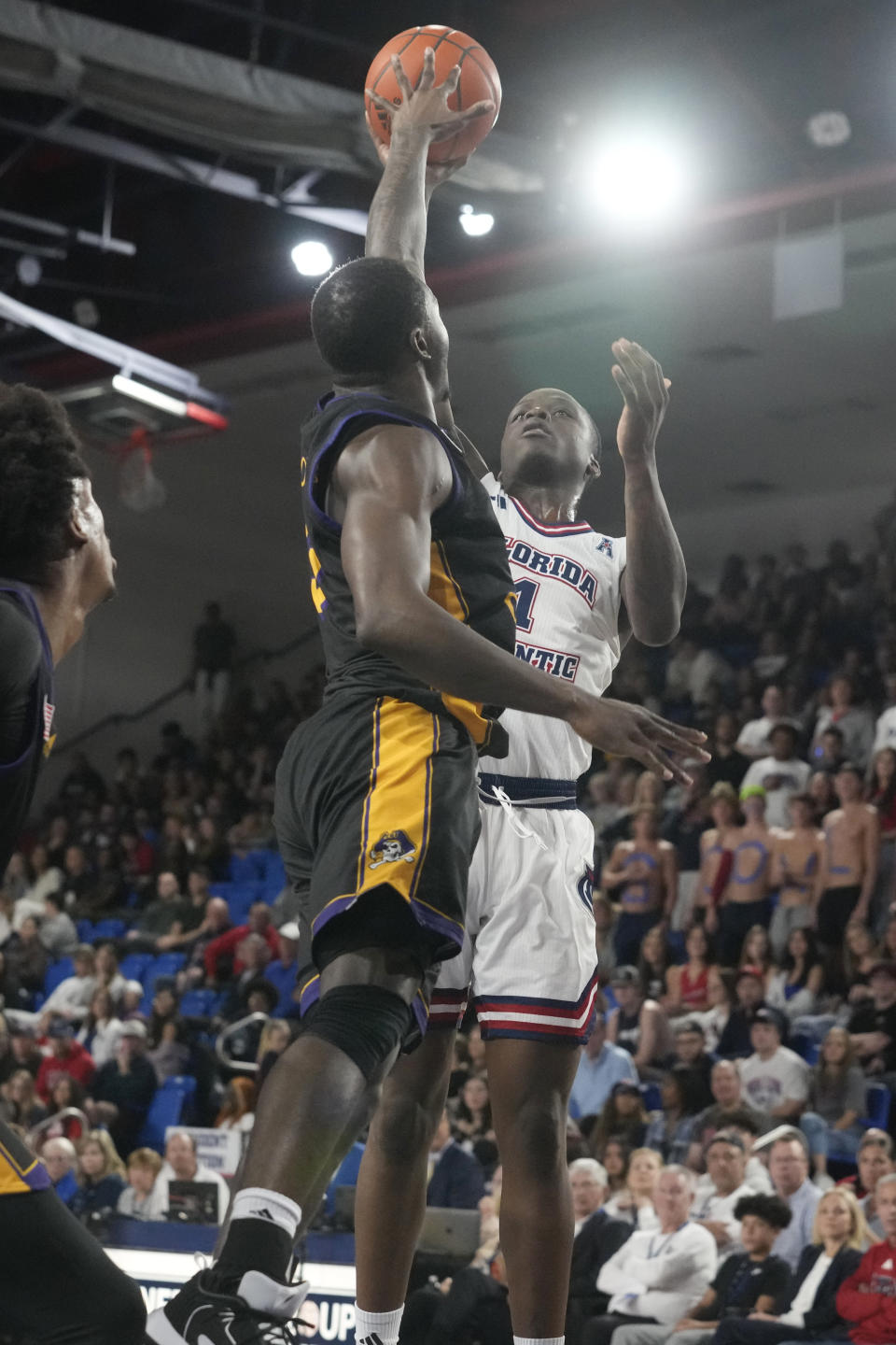 East Carolina guard RJ Felton (3) stops a drives to the basket by Florida Atlantic guard Johnell Davis (1) during the first half of an NCAA college basketball game, Tuesday, Jan. 2, 2024, in Boca Raton, Fla. (AP Photo/Marta Lavandier)