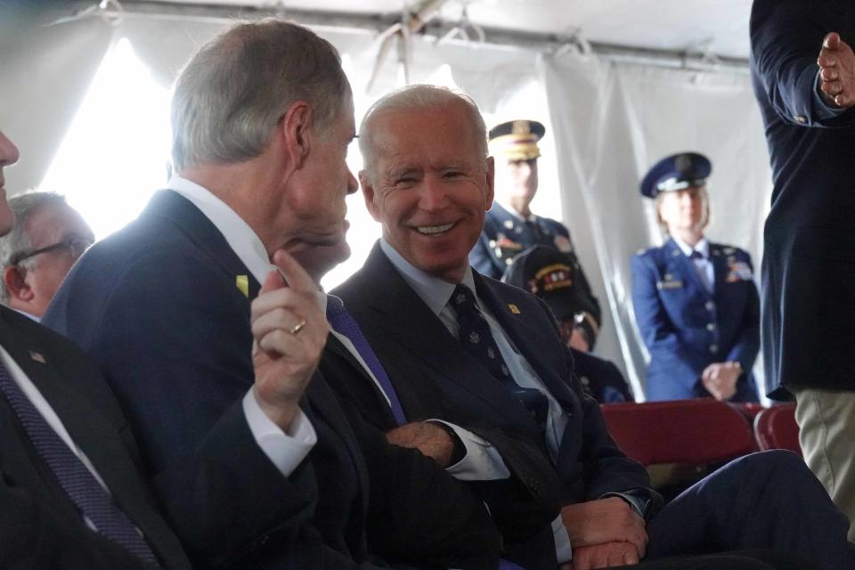 Former Vice President Joe Biden smiles while visiting with Gov. John Carney and Sen. Tom Carper during the annual Veterans Day ceremony at Delaware Memorial Bridge Veterans Memorial Park in 2020.