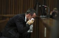 Oscar Pistorius reacts during his trial at the high court in Pretoria April 7, 2014. REUTERS/Themba Hadebe/Pool