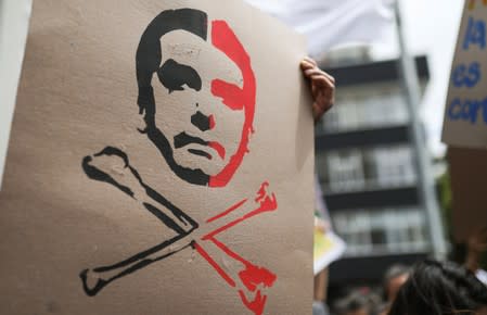 People protest outside the Brazilian embassy due to the wildfires in the Amazon rainforest, in Bogota