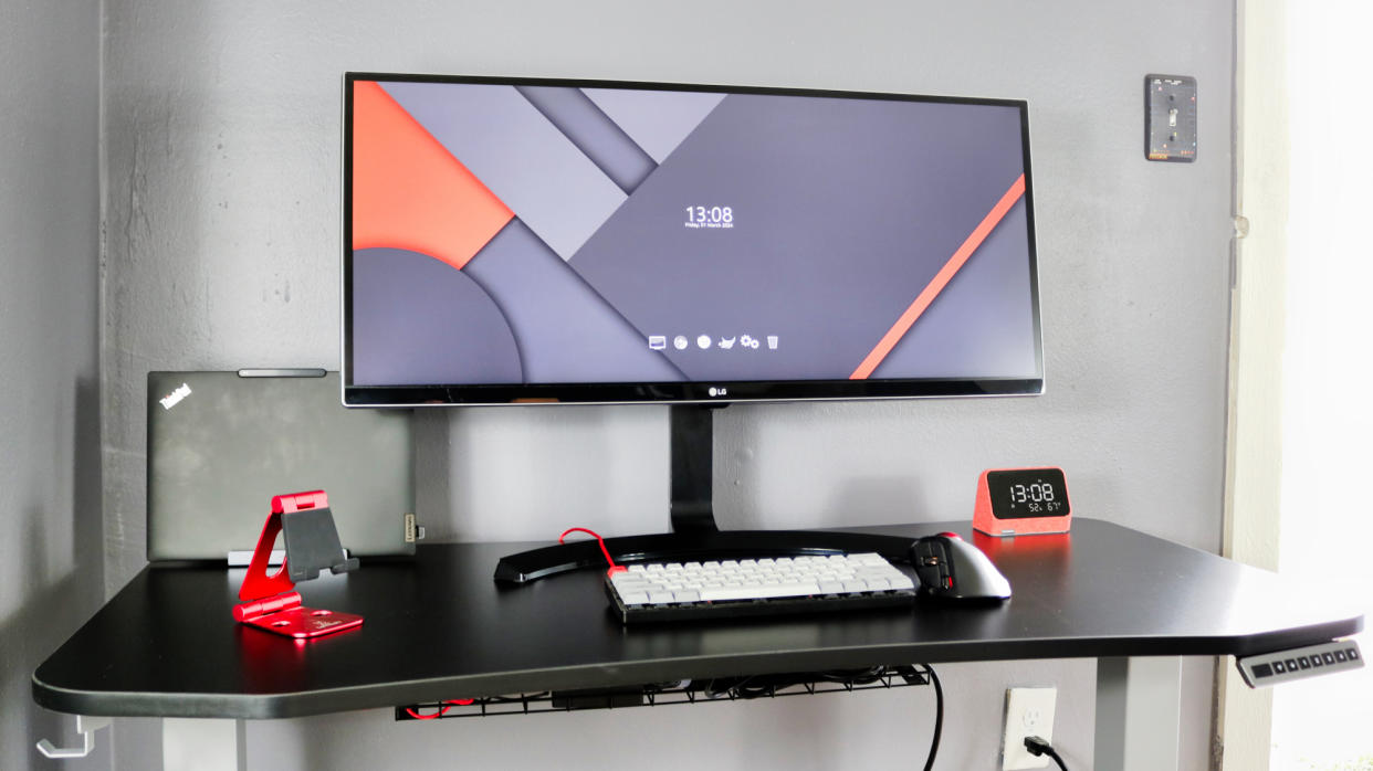  A picture of a desk setup with an ultrawide monitor and a laptop docked in the Ugreen Steam Deck dock. 