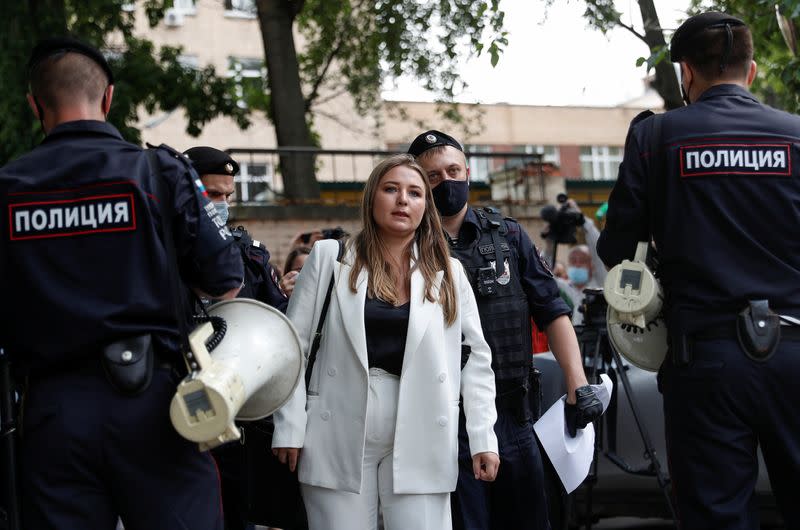 Policemen detain a woman during a picket in support of former journalist Ivan Safronov in Moscow