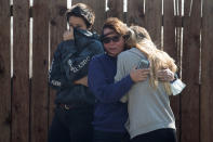 <p>Local residents react as numerous homes burn on a hillside during a wind driven wildfire in Ventura, Calif., Dec. 5, 2017. (Photo: Mike Blake/Reuters) </p>