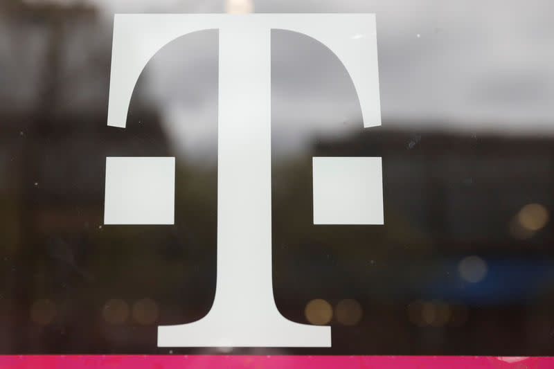 A T-Mobile logo is seen on the storefront door of a store in Manhattan, New York, U.S., April 30, 2018. REUTERS/Shannon Stapleton