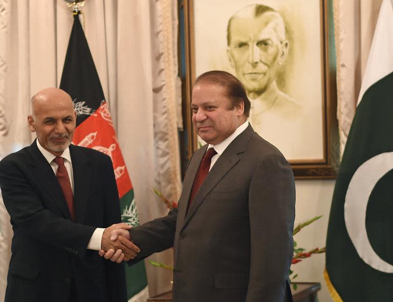 Afghan President Ashraf Ghani (left) and Pakistani Prime Minister Nawaz Sharif shake hands ahead of talks in Islamabad, on November 15, 2014