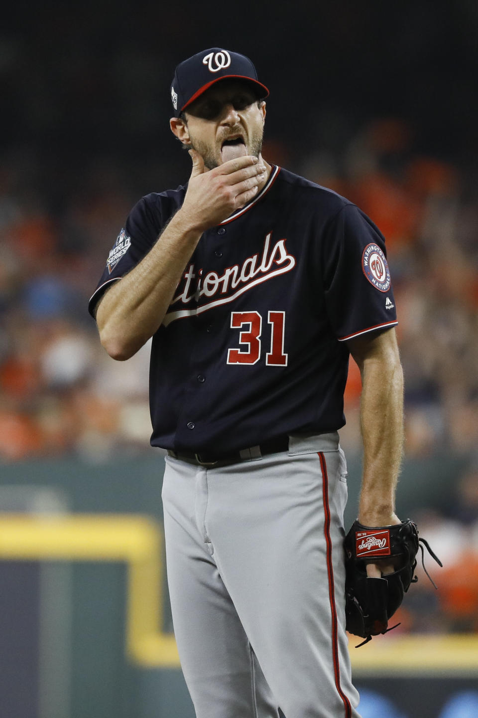 Washington Nationals starting pitcher Max Scherzer wipes his face during the first inning of Game 1 of the baseball World Series against the Houston Astros Tuesday, Oct. 22, 2019, in Houston. (AP Photo/Matt Slocum)