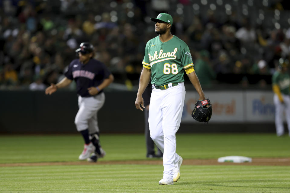 Cleveland Guardians' Josh Naylor, left, rounds the bases after hitting a two-run home off of Oakland Athletics' Domingo Acevedo (68) during the seventh inning of a baseball game in Oakland, Calif., Friday, April 29, 2022. (AP Photo/Jed Jacobsohn)