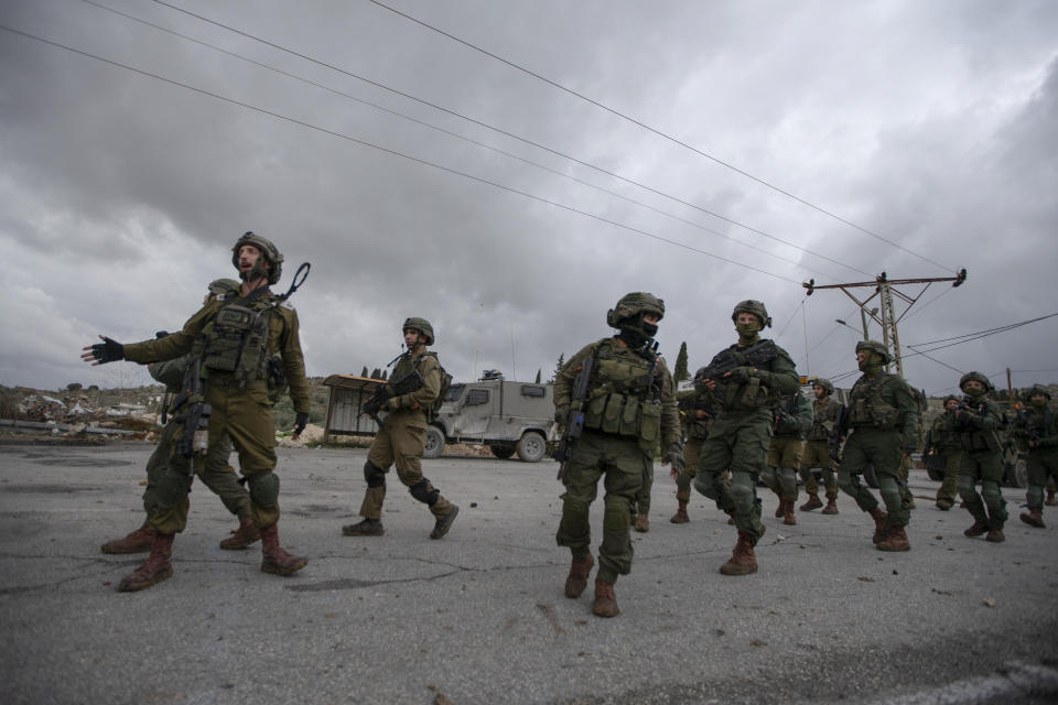 Israeli soldiers patrol in the West Bank village of Burqa, Friday, Dec. 17, 2021. Palestinian officials said at least two people have been injured in a string of Jewish settler attacks in northern West Bank villages, a day after an Israeli settler was shot dead by Palestinian gunmen. (AP Photo/Majdi Mohammed)