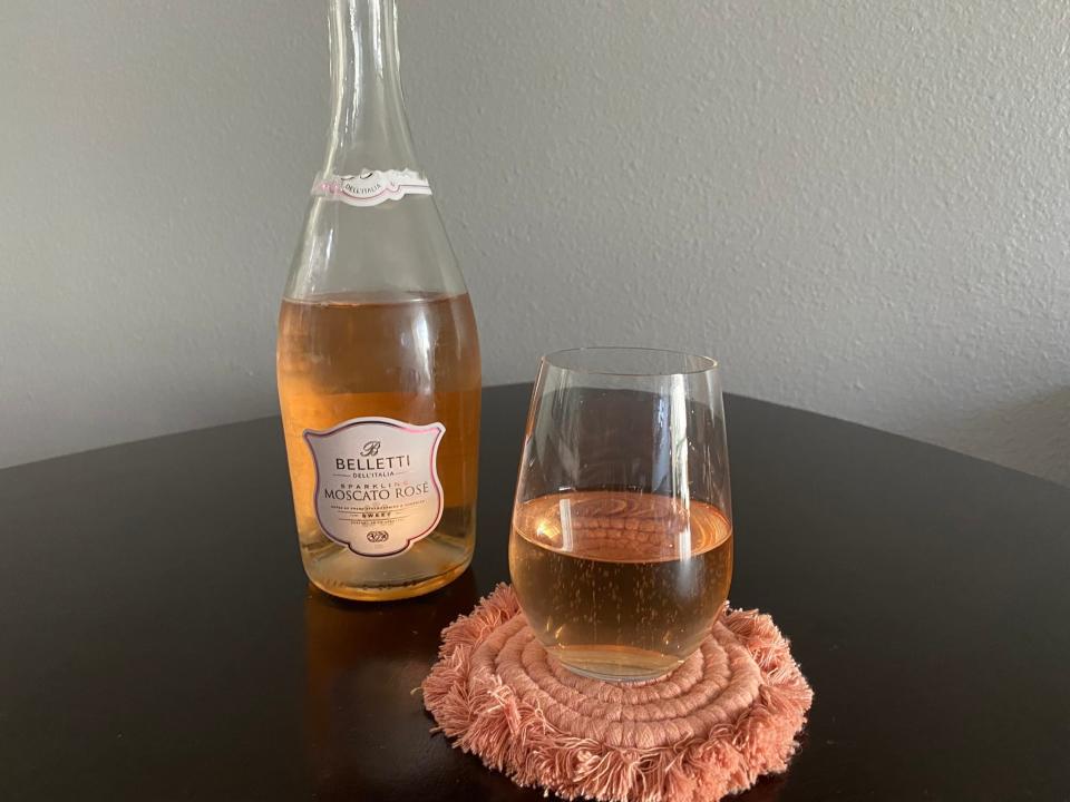 Belletti sparkling Moscato rosé with a glass of rosé next to bottle