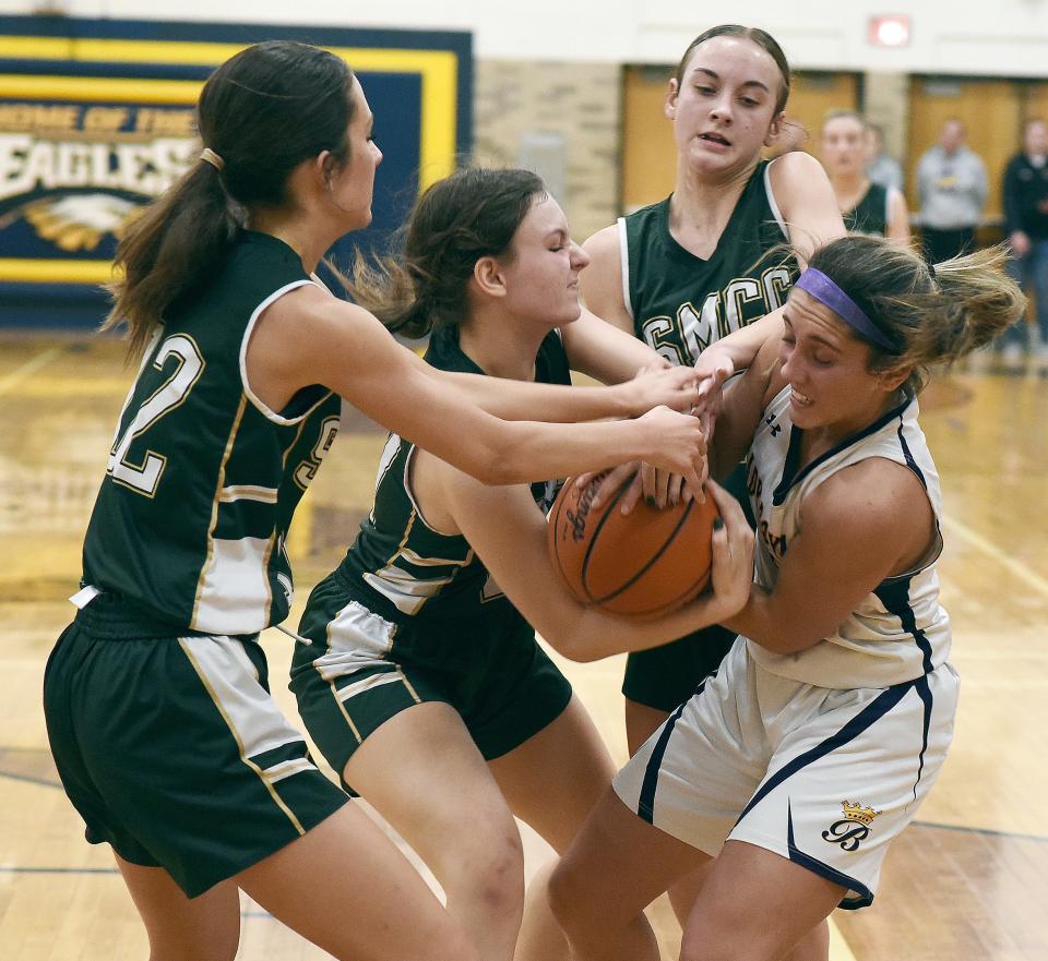 Blissfield's Avery Collins fights for the ball against Julianna Potcova, Natalie LaPrad and Bella LaFountain of St. Mary Catholic Central during Blissfield's 51-38 victory in the finals of the Division 3 District at Erie Mason on Friday, March 8, 2024.