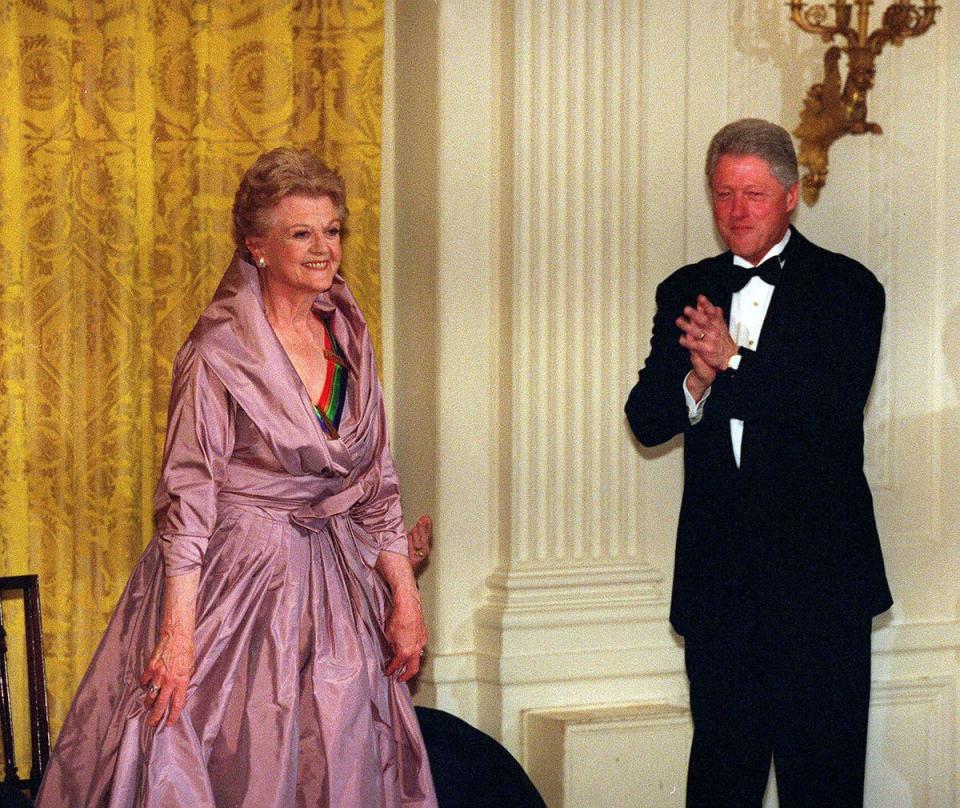 President Bill Clinton (R) welcomes actress Angela Lansbury to the White House in Washington, in 2000 (AFP via Getty Images)