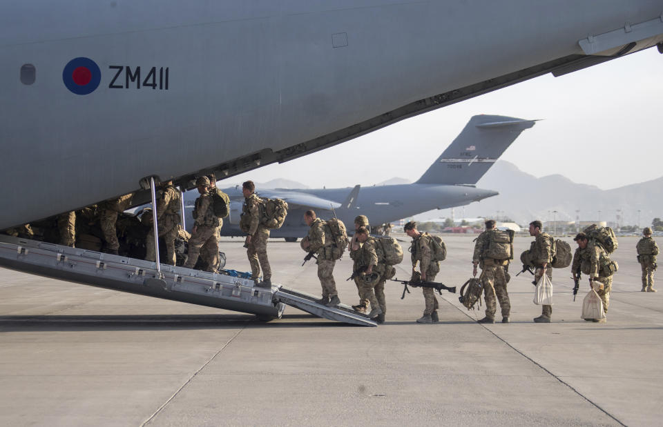 In this handout photo provided by the Ministry of Defence, UK military personnel onboard a A400M aircraft departing Kabul, Afghanistan, Saturday, Aug. 28, 2021. Britain has ended evacuation flights from Kabul airport and begun bringing U.K. troops home. Britain’s defense ministry said the final flight for Afghan citizens had left Kabul. Further flights over the weekend will bring home British troops and diplomats and a few remaining civilians. (Jonathan Gifford/Ministry of Defence via AP)