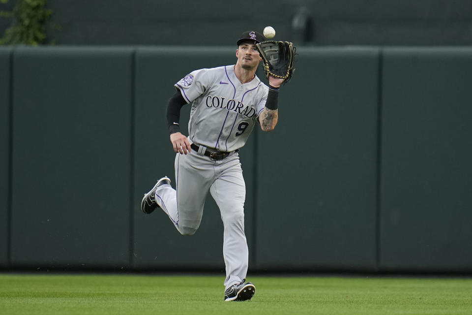 FILE - Colorado Rockies center fielder Brenton Doyle makes a catch against the Baltimore Orioles during the first inning of a baseball game, Friday, Aug. 25, 2023, in Baltimore. Doyle won a Gold Gloves, in news announced Sunday, Nov. 5, by Rawlings. (AP Photo/Julio Cortez, File)