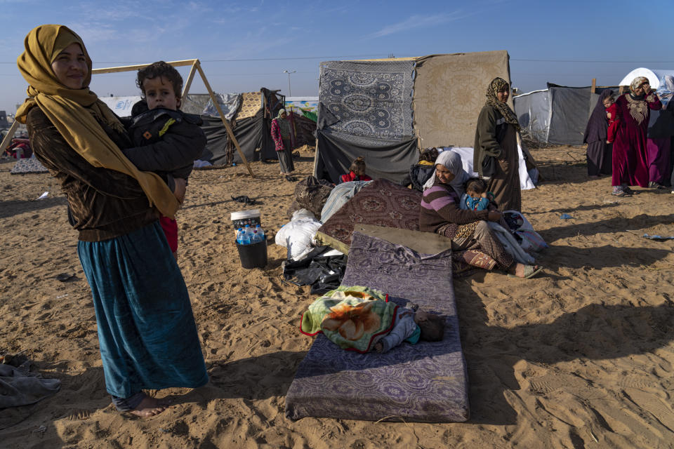 Palestinians displaced by the Israeli bombardment of the Gaza Strip gather at a tent camp, in Rafah, southern Gaza strip, Monday, Dec. 4, 2023. Hundreds of thousands of Palestinians have fled their homes as Israel moves ahead with a ground offensive against the ruling Hamas militant group. (AP Photo/Fatima Shbair)