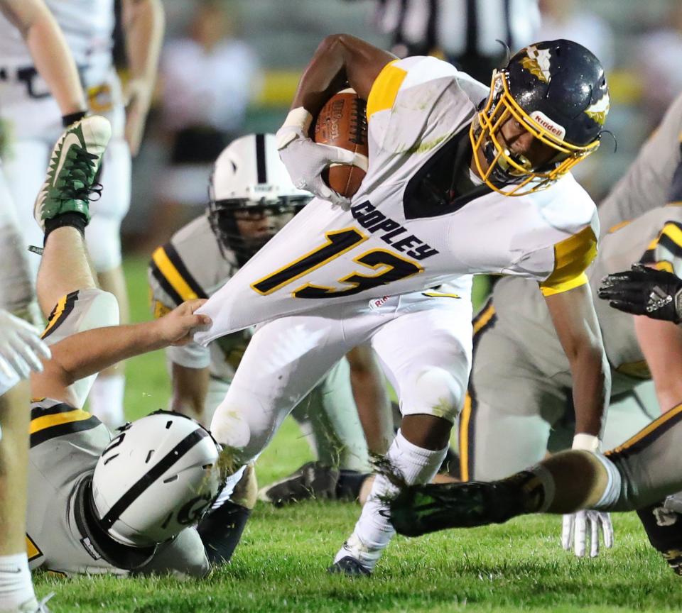 Copley running back Preston Taylor is brought down by Cuyahoga Falls linebacker Johnny Cheek during the third quarter of a football game at Clifford Stadium, Friday, Sept. 4, 2020, in Cuyahoga Falls, Ohio.