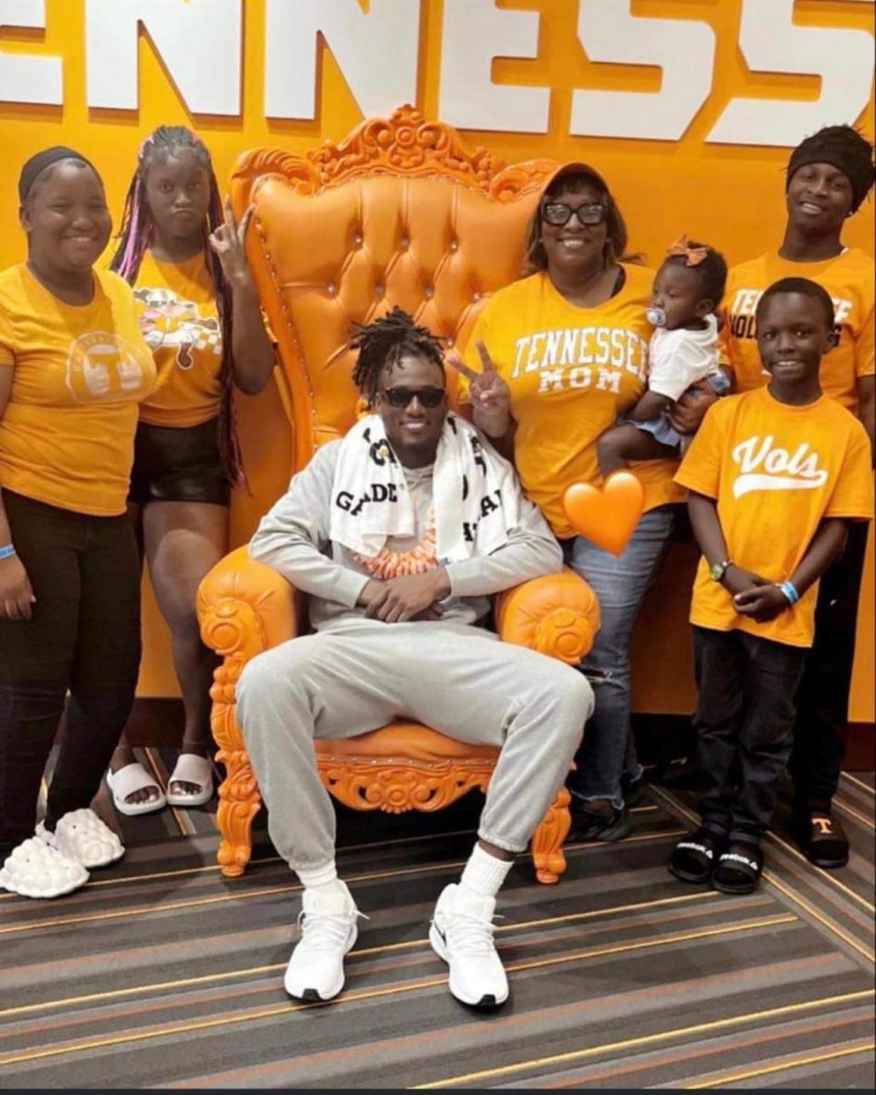 Tennessee quarterback Joe Milton, center, poses with his famiy. That includes, from left, sisters Tra’Viona and De’Aysha, mother DeShea Bouie holding 1-year-old Journey, and brothers Jo’Tavious and T.J. Their sister, Miracle, died in 2007, after a premature birth.