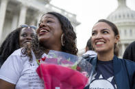 Rep. Cori Bush, D-Mo., and Rep. Alexandria Ocasio-Cortez, D-N.Y., smile after it was announced that the Biden administration will enact a targeted nationwide eviction moratorium outside of Capitol Hill in Washington on Tuesday, August 3, 2021. For the past five days, lawmakers and activists primarily led by Rep. Cori Bush, D-Mo., have been sitting in on the steps of Capitol Hill to protest the expiration of the eviction moratorium. (AP Photo/Amanda Andrade-Rhoades)