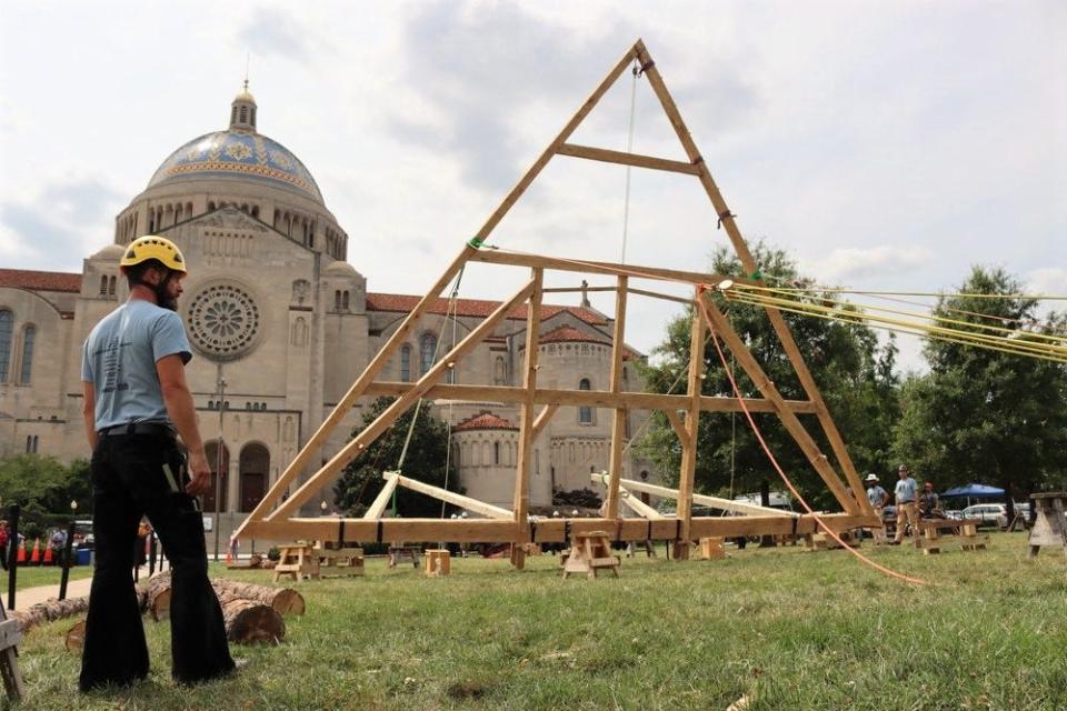 Notre Dame de Paris Truss project leader Gerry David stands near the full-scale reconstruction of the Notre Dame Cathedral's Choir Truss No. 6 in the summer of 2021 at the Catholic University of America.
