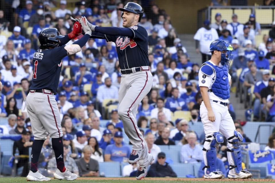 Braves' Freddie Freeman celebrates with Ozzie Albies after a two-run home run.