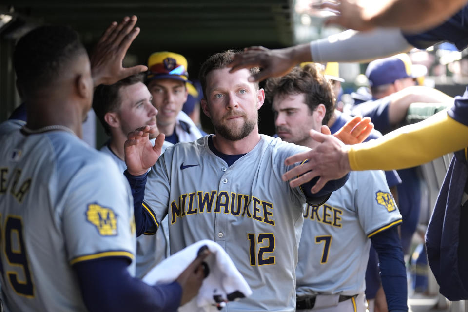Milwaukee Brewers' Rhys Hoskins is greeted in the dugout after scoring on Oliver Dunn's triple in the seventh inning of a baseball game against the Chicago Cubs Saturday, May 4, 2024, in Chicago. (AP Photo/Charles Rex Arbogast)