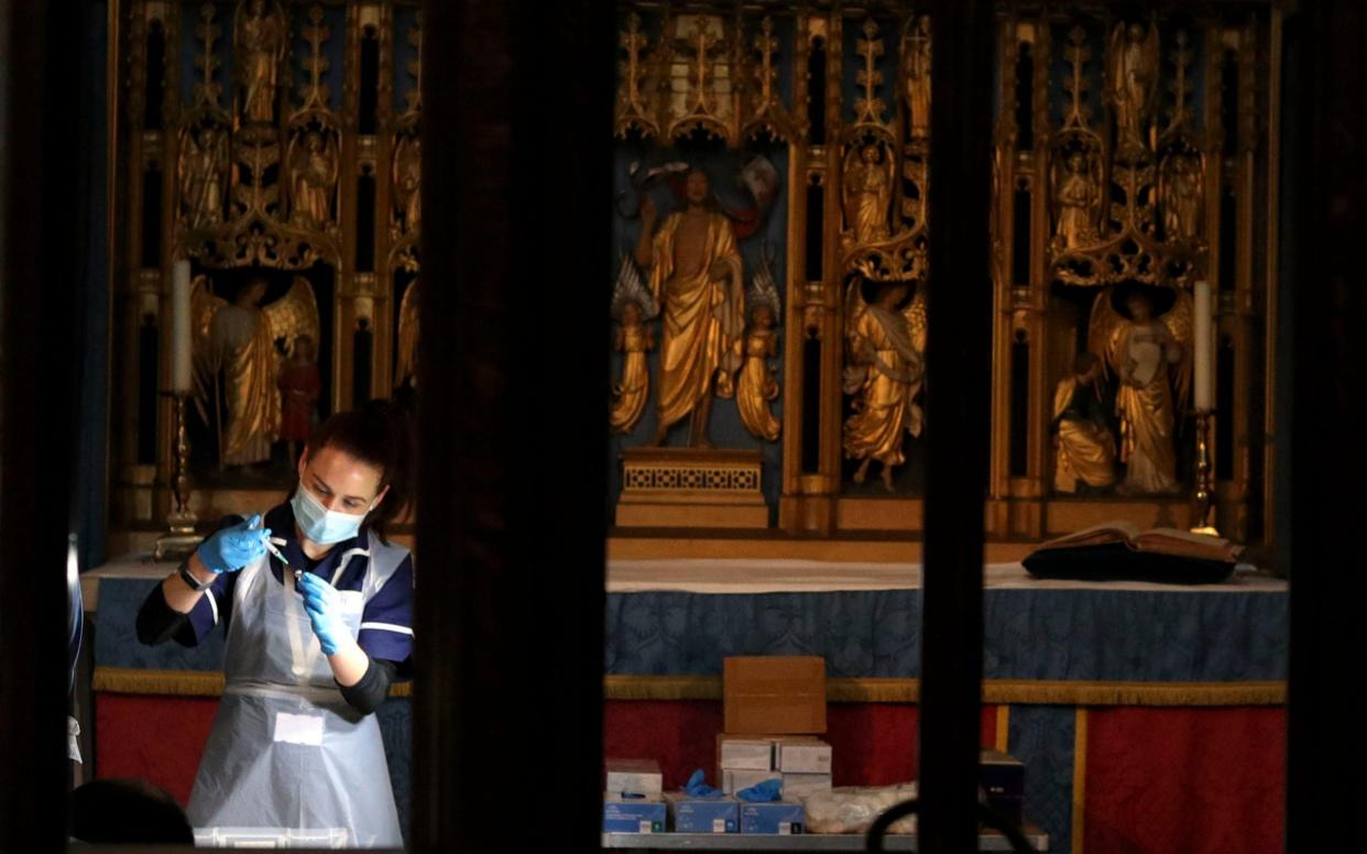 The Pfizer coronavirus vaccine is prepared by health workers at Salisbury Cathedral - Steve Parsons/PA