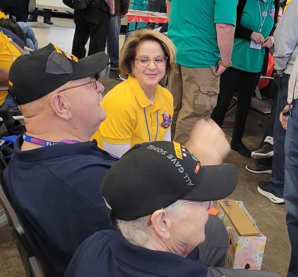 Blue Ridge Community College President Laura Leatherwood sits with her veteran, Bill Davis, at Asheville Regional Airport prior to boarding the April 27 Blue Ridge Honor Flight.