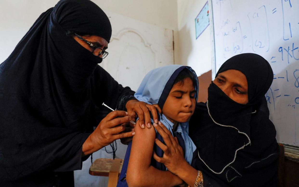 A student in Pakistan receives the new anti-typhoid vaccine, which has performed impressively in the first field trial - REUTERS