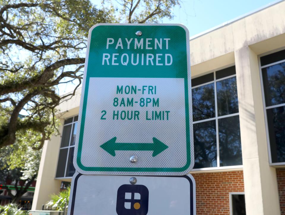 A sign from the City of Gainesville telling motorist they have to pay for two hours of parking at many of the spaces that had been free, in Gainesville on Jan. 18, 2022.