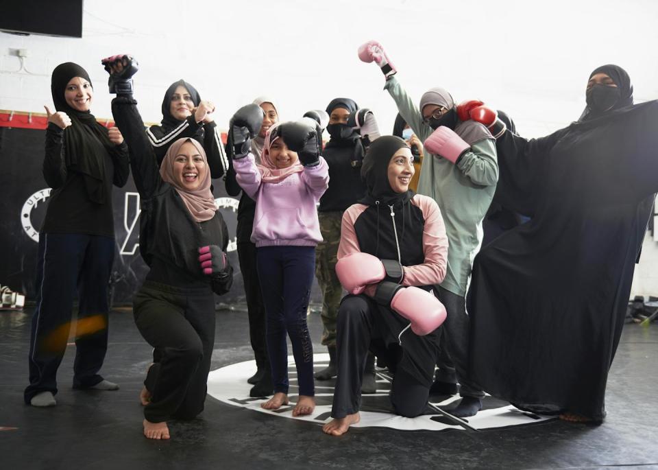 Women wearing hijab smile for a portrait.