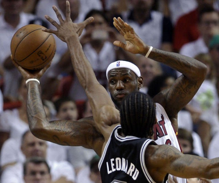 LeBron James of the Miami Heat is guarded by Kawhi Leonard of the San Antonio Spurs on June 9, 2013. James finished with 17 points and seven assists as Miami routed San Antonio 103-84 in game two of the NBA finals