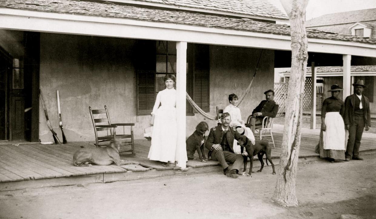 A group of men and women, including two soldiers, on a porch in Fort Verde, Ariz., in 1886. <a href="https://www.gettyimages.com/detail/news-photo/two-soldiers-and-two-women-on-porch-with-afro-american-news-photo/90001097?adppopup=true" rel="nofollow noopener" target="_blank" data-ylk="slk:Buyenlarge/Getty Images;elm:context_link;itc:0;sec:content-canvas" class="link ">Buyenlarge/Getty Images </a>