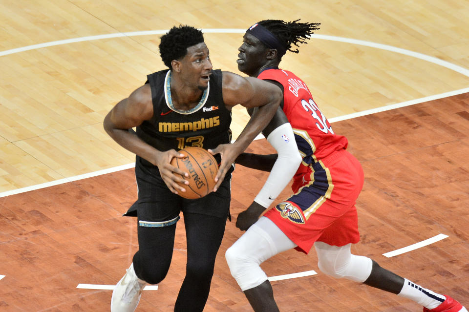 Memphis Grizzlies forward Jaren Jackson Jr., left, handles the ball against New Orleans Pelicans forward Wenyen Gabriel, right, in the first half of an NBA basketball game Monday, May 10, 2021, in Memphis, Tenn. (AP Photo/Brandon Dill)