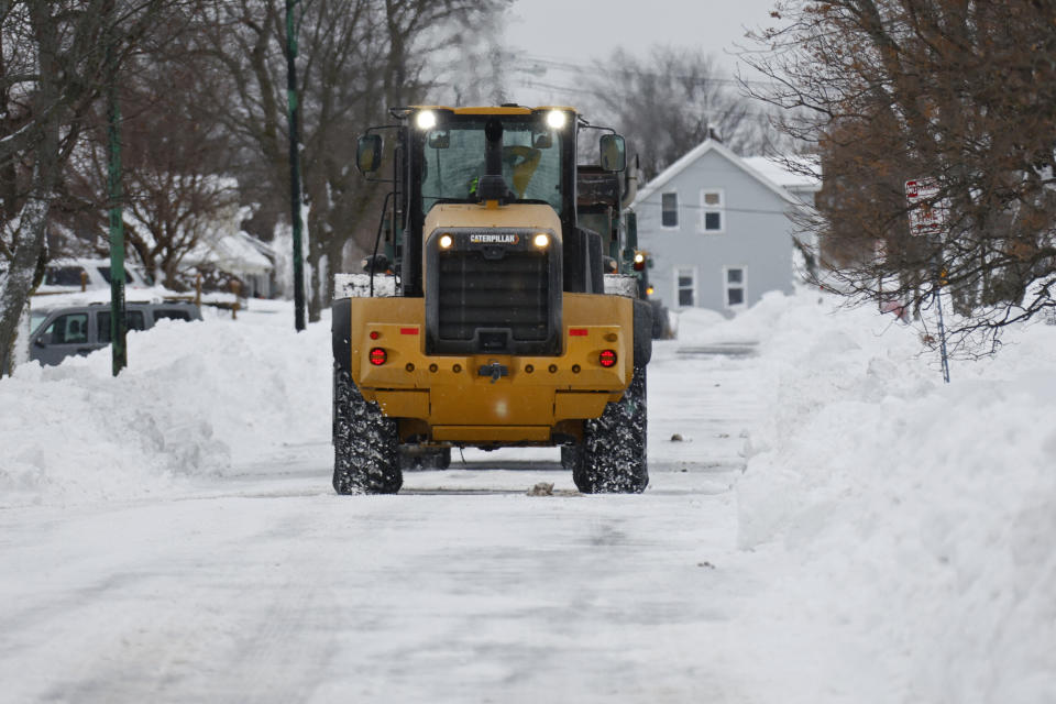 A payloader helps with snow removal after a winter storm rolled through Western New York Tuesday, Dec. 27, 2022, in Amherst, N.Y. (AP Photo/Jeffrey T. Barnes)