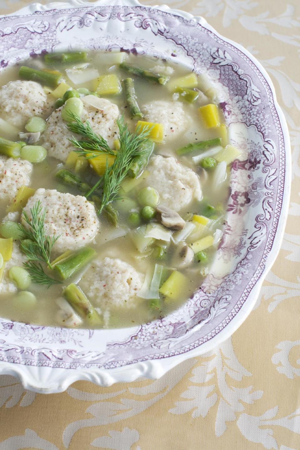 In this March 4, 2013 photo, spring vegetable soup with low-fat, high-flavor matzo balls is shown in a soup tureen in Concord, N.H. (AP Photo/Matthew Mead)