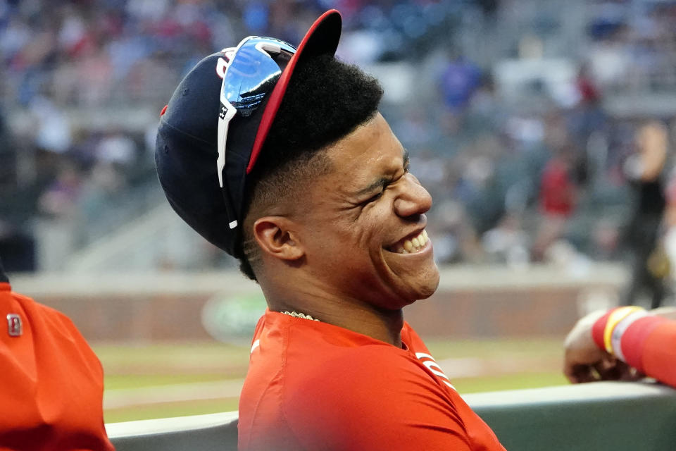 Washington Nationals left fielder Juan Soto (22) laughs with teammates in the dugout during a baseball game against the Atlanta Braves, Friday, Aug. 6, 2021, in Atlanta. Soto was not in the starting line up. (AP Photo/John Bazemore)