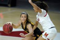 Iowa guard Gabbie Marshall, left, works the floor against Maryland guard Katie Benzan during the first half of an NCAA college basketball game, Tuesday, Feb. 23, 2021, in College Park, Md. (AP Photo/Julio Cortez)