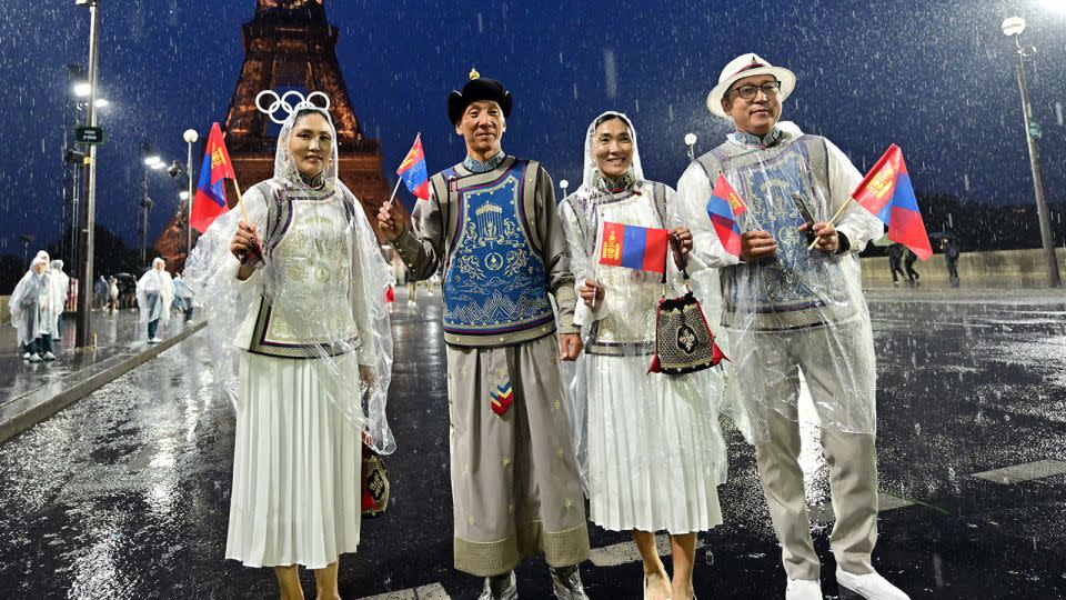 Members of Mongolia's delegation pose on the Jena Bridge during the opening ceremony of the Paris 2024 Olympic Games on July 26, 2024. - Martin Bernetti/AFP/Getty Images