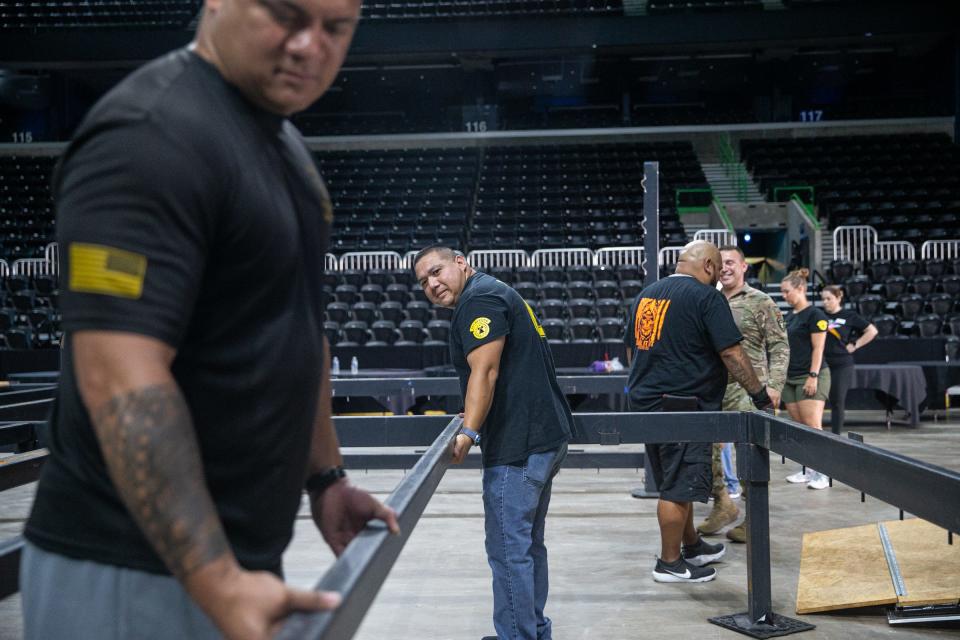 Junior Olympic Boxing event preparation volunteers, from left, U.S. Army Staff Sgt. LBJ Maluia and Sgt. 1st Class Robert Hernandez, place support beams for a boxing ring at the American Bank Center on Thursday, June 9, 2022, in Corpus Christi, Texas. 