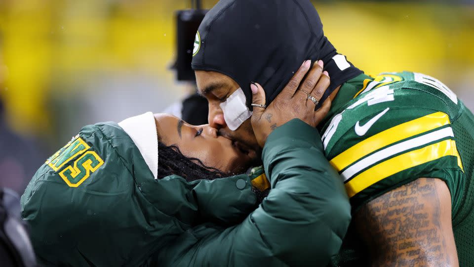 Biles and Owens share a kiss before kickoff on Sunday. - Stacy Revere/Getty Images