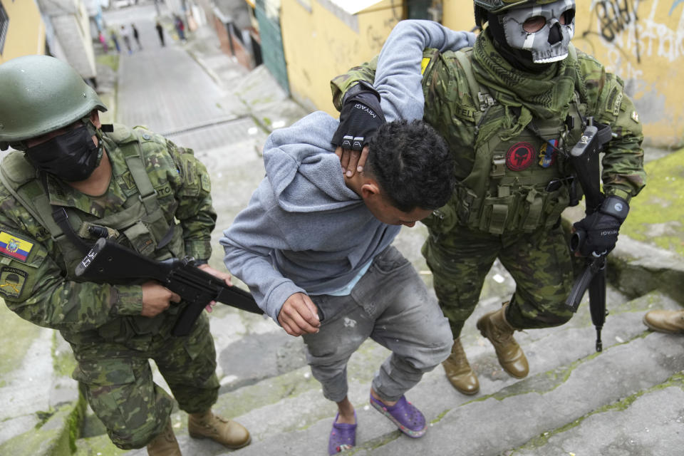 Soldiers briefly detain a youth to walk him to an area to check if he has gang-related tattoos as they patrol the south side of Quito, Ecuador, Friday, Jan. 12, 2024, in the wake of the apparent escape of a powerful gang leader from prison. President Daniel Noboa decreed Monday a national state of emergency, a measure that lets authorities suspend people’s rights and mobilize the military. (AP Photo/Dolores Ochoa)