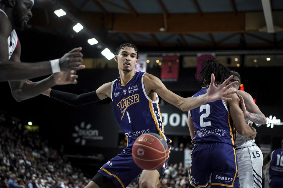 Boulogne-Levallois' Victor Wembanyama follows the ball during the Elite basketball match Boulogne-Levallois against JDA Dijon at the Palais de Sports Jean-Michel Geoffroy in Dijon, central France, Sunday, Jan. 15, 2023. On Sunday, May 7, 2023, he played before a crowd of about 15,000 fans in Paris as part of his farewell tour before coming to the NBA. Wembanyama is about a week away from learning which team will be picking him in the NBA Draft. (AP Photo/Laurent Cipriani)